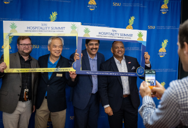 Attendees post for a photo at the Hospitality Summit